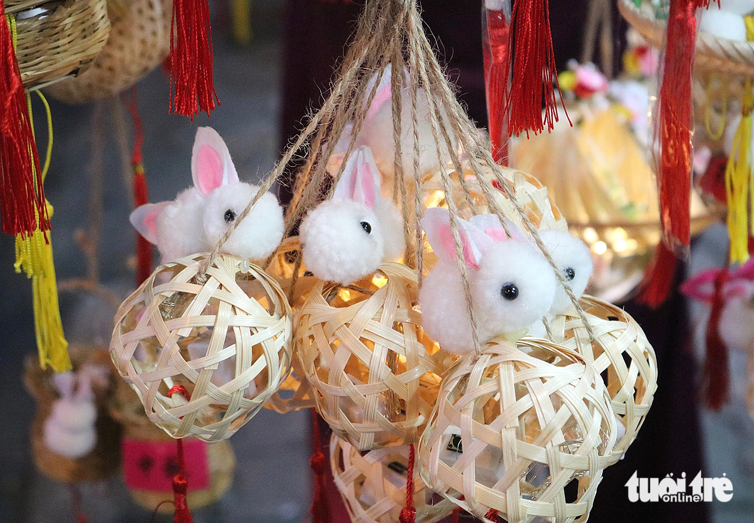 <em>Stuffed bunny toys are attached to bamboo lanterns.</em>